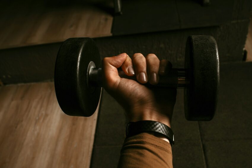 a person lifting a barbell in a gym